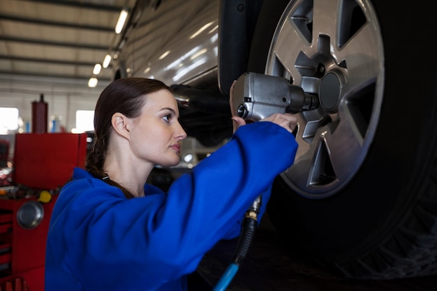 mechanic using computerized alignment tool on a car